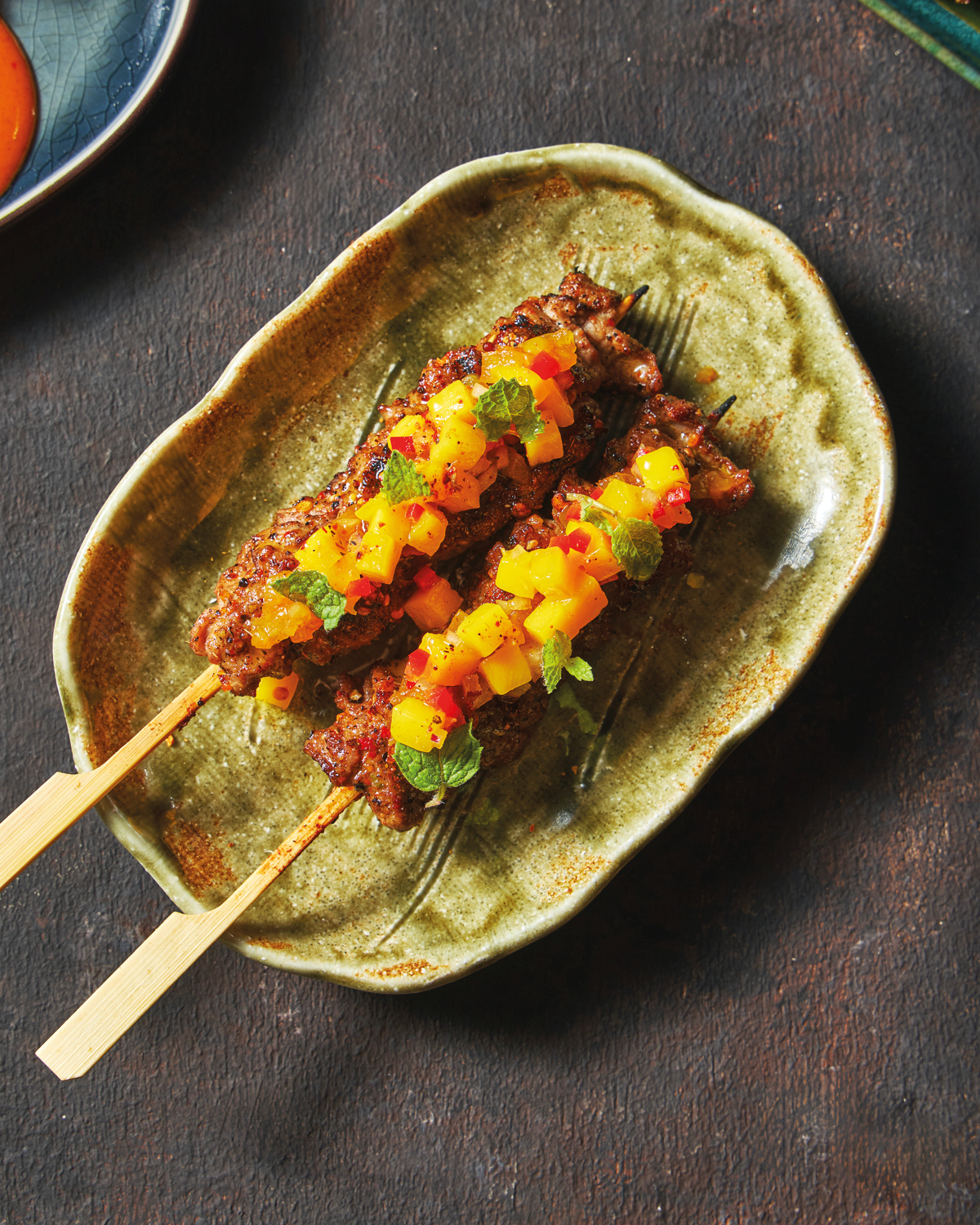 New Zealand lamb shoulder skewers with colorful mango salsa and fresh mint